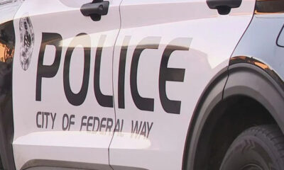 Side view of a white police SUV with large 'POLICE' lettering and 'City of Federal Way' on the door.