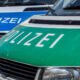Close-up of two German police vans, green and blue fronts with 'POLIZEI' lettering.
