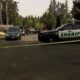 Sheriff patrol SUV blocks a residential street with yellow tape as investigators work in the background.