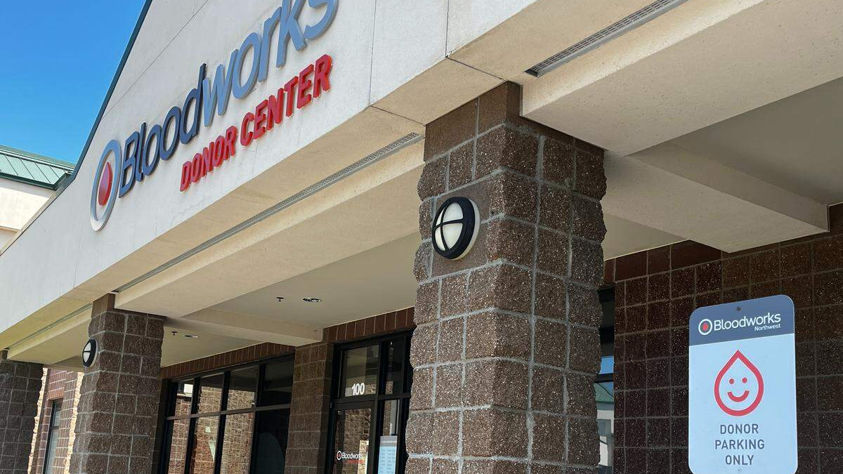 Exterior of Bloodworks Northwest Donor Center with brick columns and donor parking sign in front