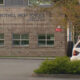 Exterior of Bothell High School building with a stone facade and a white SUV in the parking lot.