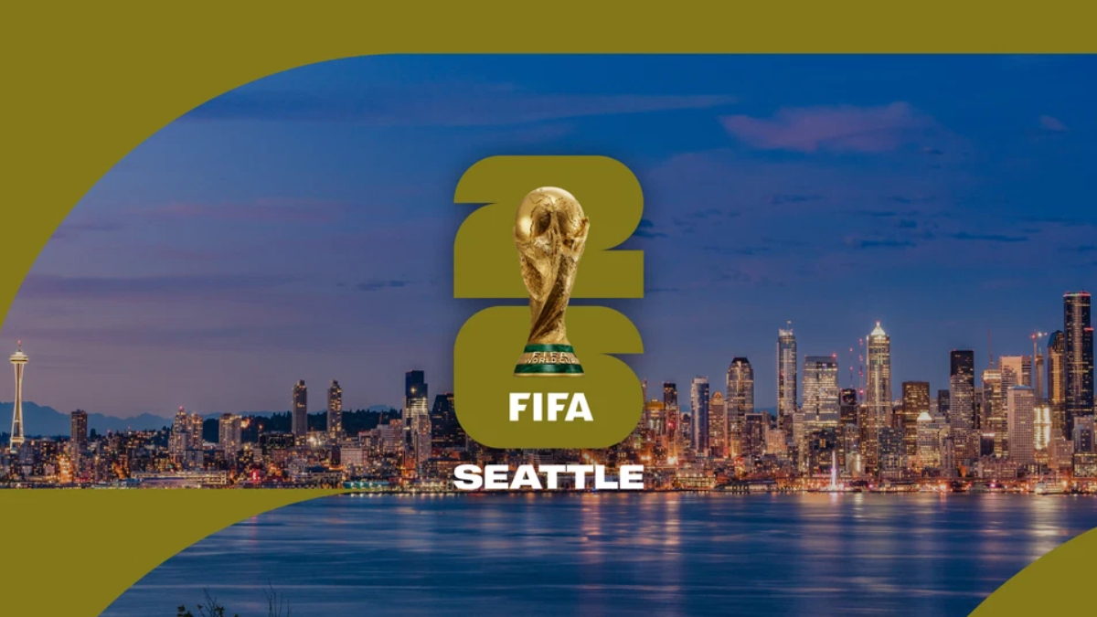 Seattle FIFA World Cup banner showing the trophy above the 'FIFA SEATTLE' text over a city skyline at dusk.