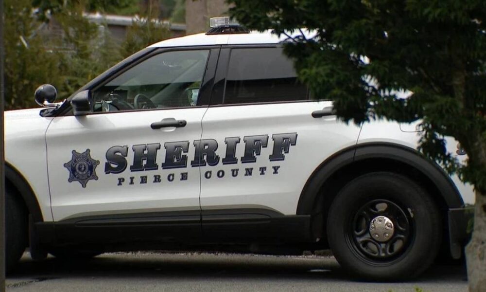 White sheriff's patrol SUV with 'SHERIFF' and 'PIERCE COUNTY' on the side, parked beside trees.