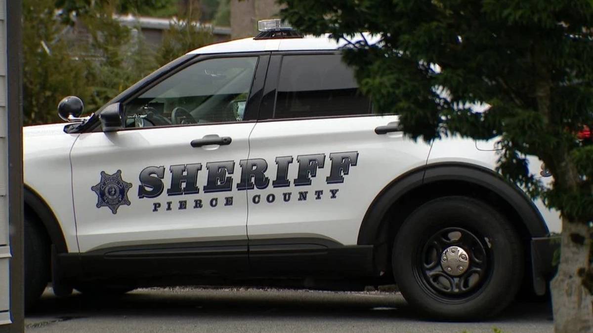 White sheriff's patrol SUV with 'SHERIFF' and 'PIERCE COUNTY' on the side, parked beside trees.