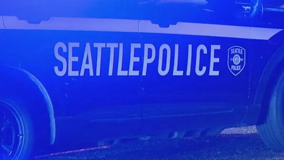 Side view of a Seattle Police Department patrol car with bold 'SEATTLEPOLICE' lettering and the department shield.