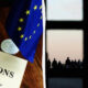 Split image: left—document labeled SANCTIONS with EU flag; right—silhouetted people outside a window with the Kremlin clock tower in view on the horizon.