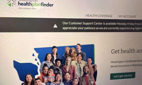 Group photo of diverse people smiling together in front of a blue map graphic on a health insurance website banner (Washington Healthplanfinder).