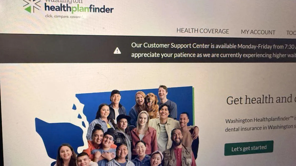 Group photo of diverse people smiling together in front of a blue map graphic on a health insurance website banner (Washington Healthplanfinder).