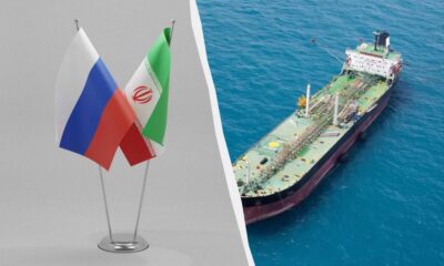 Left: Russian and Iranian flags on flagpoles; right: an oil tanker sailing in blue sea.