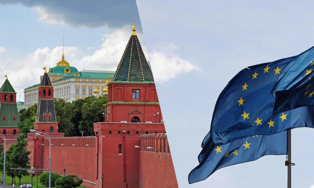 Split view: Moscow Kremlin red brick towers and wall on the left, and a blue European Union flag on the right, symbolizing East–West relations.