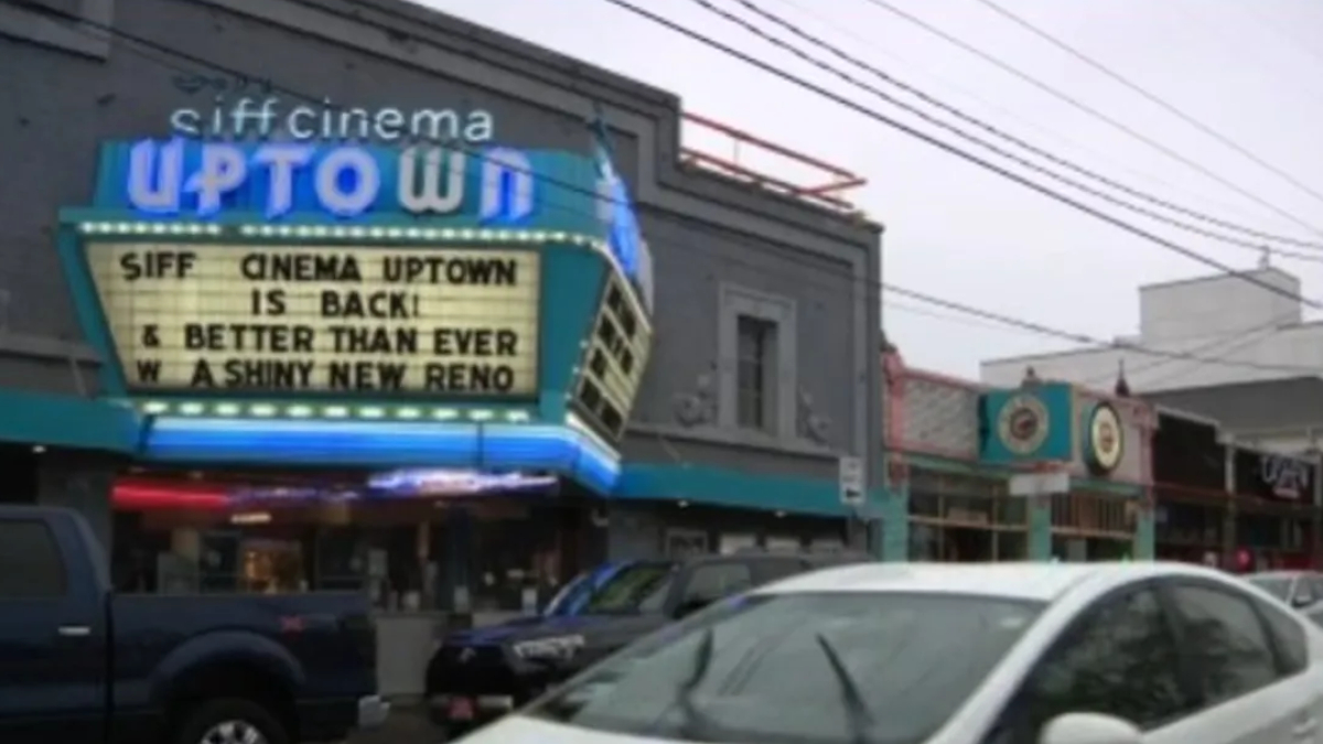Marquee sign for SIFF Cinema Uptown announcing 'SIFF CINEMA UPTOWN IS BACK & BETTER THAN EVER' on a busy street.