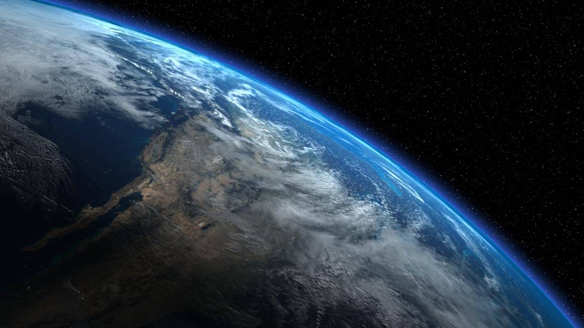 Earth's curved horizon from space, with blue atmospheric glow and starry backdrop