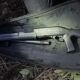 Disassembled shotgun in a padded case, with barrel, receiver, and stock laid out for transport.