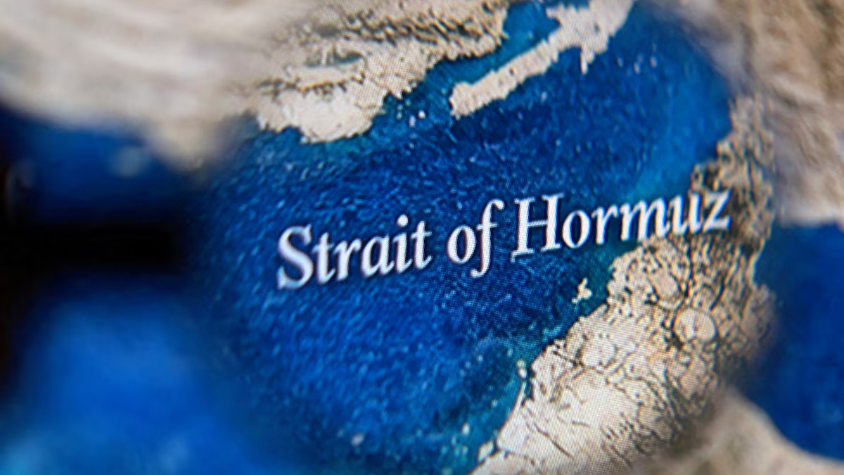 Close-up of a map highlighting the Strait of Hormuz, with blue ocean and surrounding beige land.