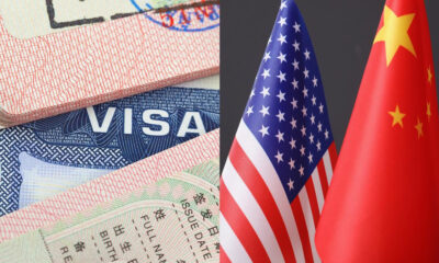 Visa documents and passports beside US and Chinese flags, suggesting international travel or immigration themes.