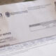 Person holding a FedLoan Servicing loan notice document dated March 11, 2016.