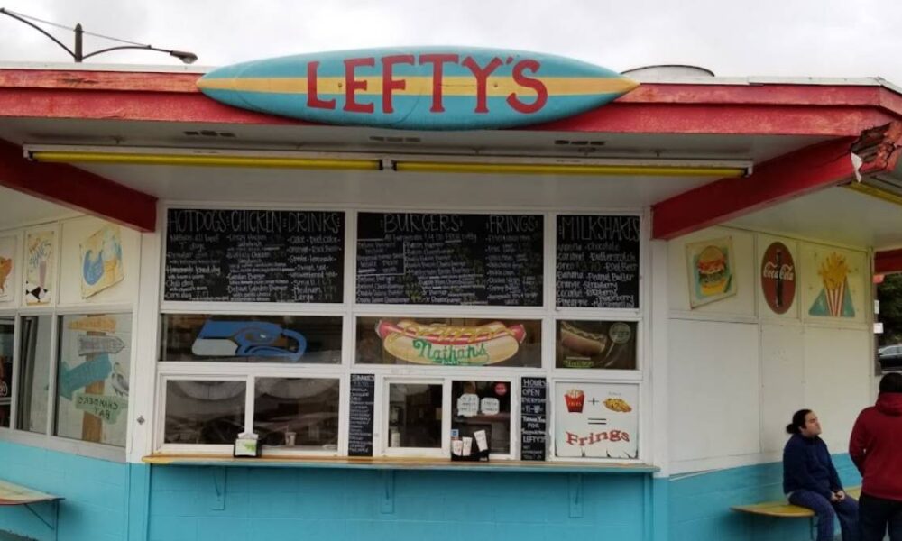 Colorful roadside food stand named Lefty's with chalk-menu boards above the windows and a turquoise-blue base.