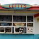 Colorful roadside food stand named Lefty's with chalk-menu boards above the windows and a turquoise-blue base.