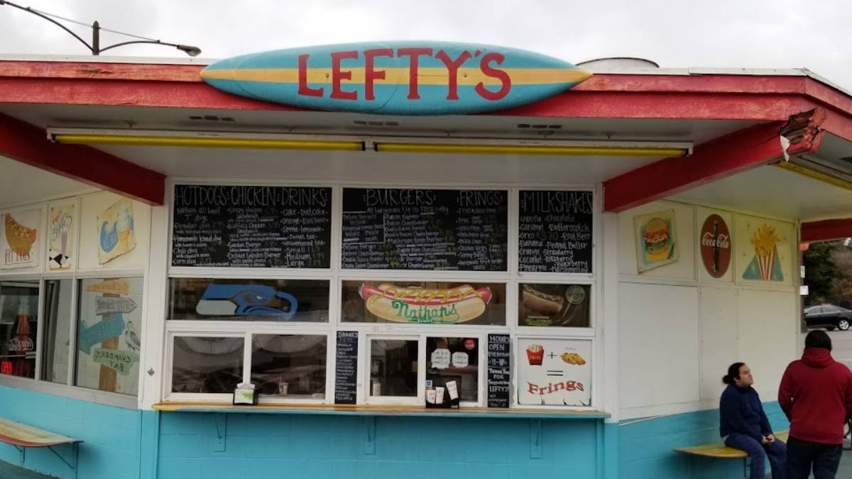 Colorful roadside food stand named Lefty's with chalk-menu boards above the windows and a turquoise-blue base.