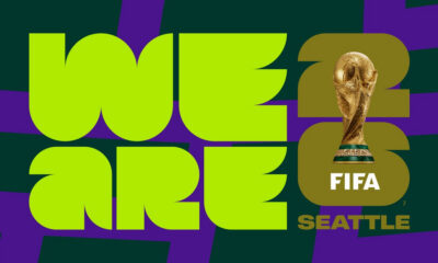 Bright lime-green poster with bold typography forming 'World Cup 2022' and a FIFA World Cup trophy over the number 22, plus 'Seattle' text.
