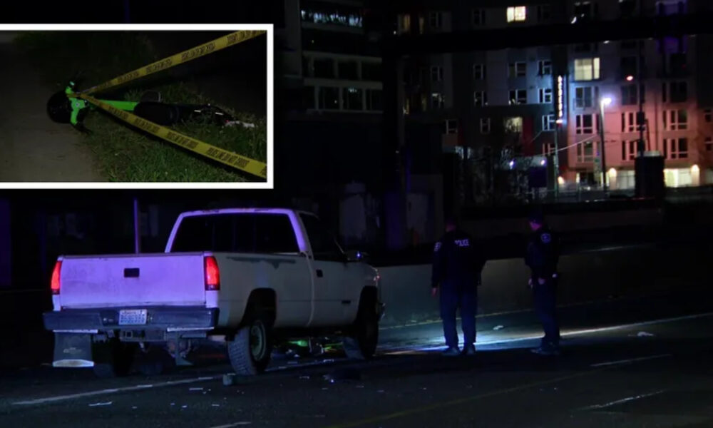 Nighttime crime-scene: a white pickup truck stopped on a street with police tape and two officers nearby, urban buildings in the background.