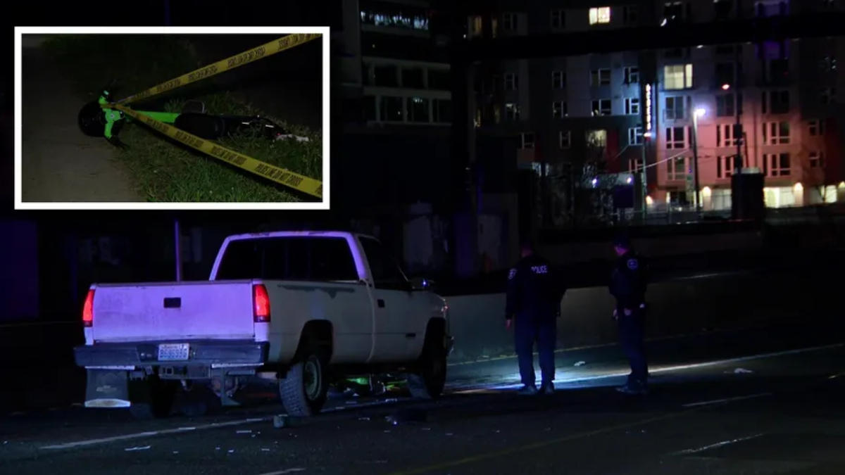 Nighttime crime-scene: a white pickup truck stopped on a street with police tape and two officers nearby, urban buildings in the background.