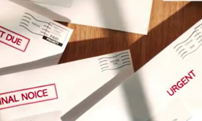 Envelopes with bold red labels reading Final Notice and Urgent, suggesting overdue bills or important mail on a wooden surface