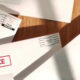Envelopes with bold red labels reading Final Notice and Urgent, suggesting overdue bills or important mail on a wooden surface