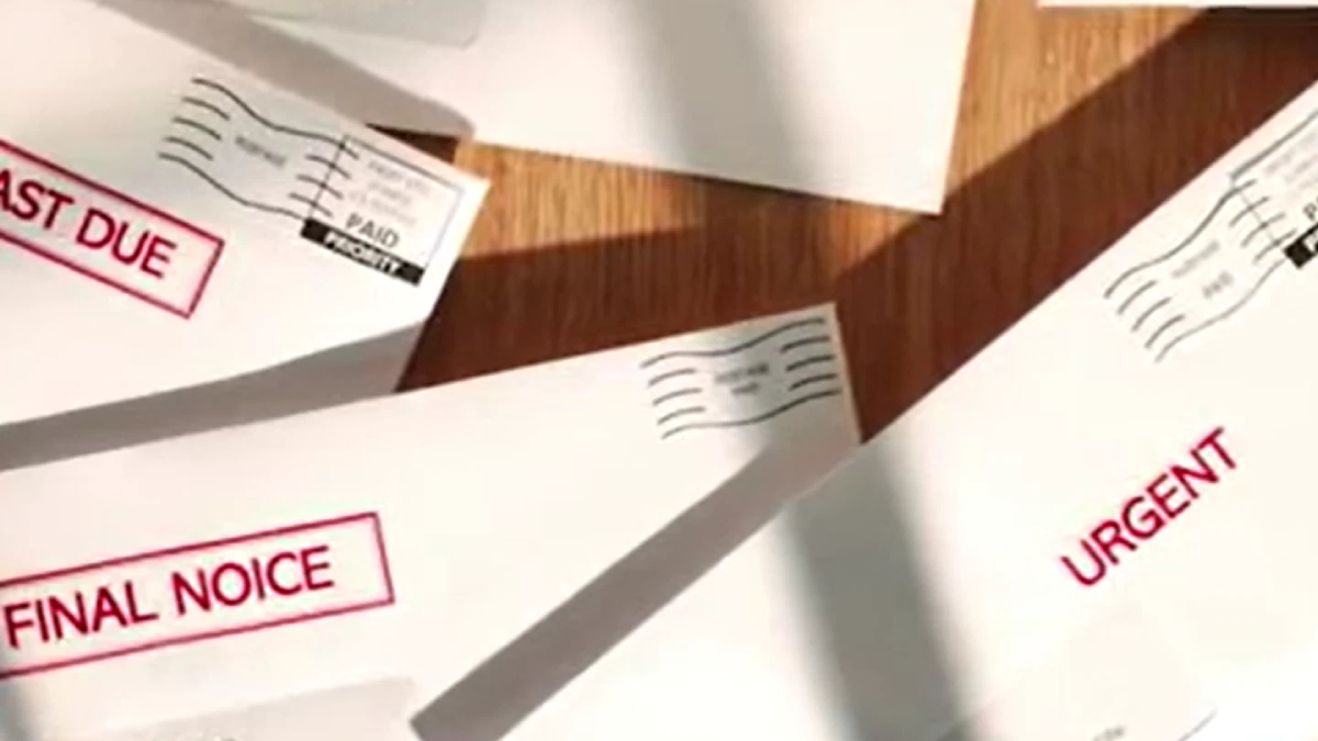 Envelopes with bold red labels reading Final Notice and Urgent, suggesting overdue bills or important mail on a wooden surface