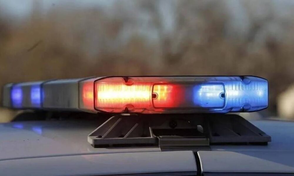 Police car roof light flashing red and blue, signaling an emergency.