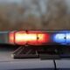 Police car roof light flashing red and blue, signaling an emergency.