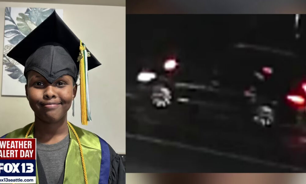 Young graduate in cap and gown posing indoors with a weather alert graphic at the corner and a green stole on, celebrating a milestone.
