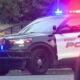 Kent Police SUV with blue and red emergency lights activated on a street, front grille guard visible.