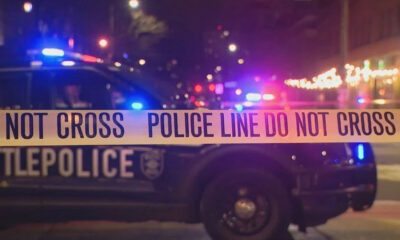 Police car with flashing lights behind yellow ‘Do Not Cross’ tape at night, indicating a crime scene.CTRL lines show police presence and blocked area.