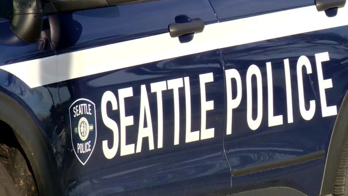 Side view of a Seattle Police Department patrol car with large 'SEATTLE POLICE' lettering and badge logo on the door