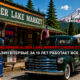 Vintage Alder Lake Market storefront with a classic dark green car parked outside and retro gas pumps against a mountain backdrop.