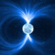 Small icy planet in space with bright blue magnetic field lines looping around it.