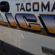 Side of a Tacoma police van with large 'POLICE' lettering and 'Tacoma' above it on the body panel.