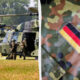 Military helicopters on a grassy airfield with soldiers approaching the open doors to board the aircraft, preparing for deployment, daytime.