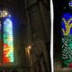 Stained glass church window with vibrant abstract landscape in blue, green, red, and yellow hues; stone arches nearby and a statue in foreground (left).