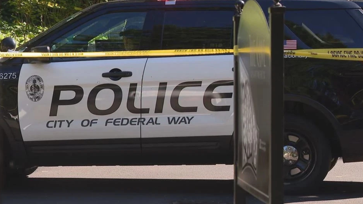 Police SUV with 'POLICE' and 'City of Federal Way' markings, yellow caution tape across the scene.