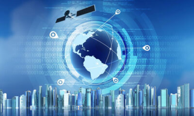 Digital globalization concept with Earth surrounded by network lines and satellites over a futuristic city skyline.