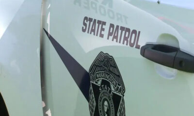 Washington State Patrol vehicle door with badge emblem and 'STATE PATROL' lettering visible