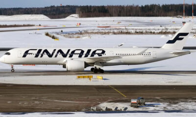 White Finnair passenger jet on a snow-covered airport tarmac, logo prominently displayed on the fuselage.