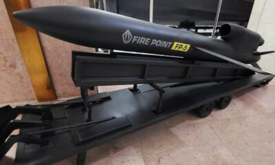 Large black FP-5 Fire Point torpedo/torpedo-like model on a wheeled display trailer indoors.