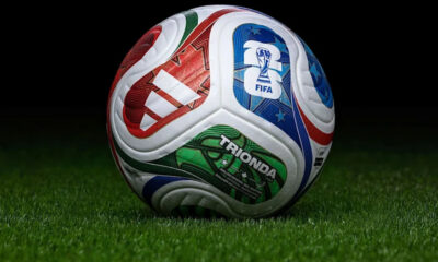 Colorful FIFA-branded soccer ball resting on green grass.