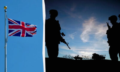 Union Jack flag on a pole with blue sky on the left, silhouettes of soldiers and tanks on a hill on the right at dusk.