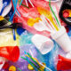 Pile of colorful plastic waste with cups, utensils, straws and bags scattered everywhere, highlighting single-use plastics.