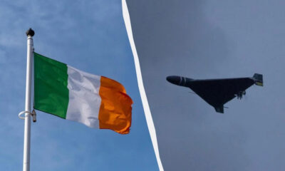 Irish flag waving on a flagpole on the left, a bomber jet in flight on the right, divided by a curved white line.