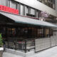 Exterior of a Benihana restaurant with outdoor seating under a large white awning/terrace.